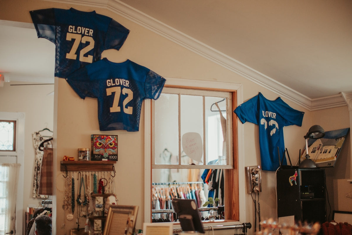 A football jersey hangs in the corner of a room